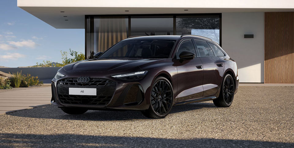 Ein Audi A6 Avant in Seitenansicht geparkt vor einem Beton-Geb&auml;ude